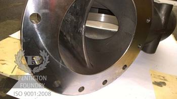 The discharge end of a chrome white iron pump casing, showing integral splitter vane.